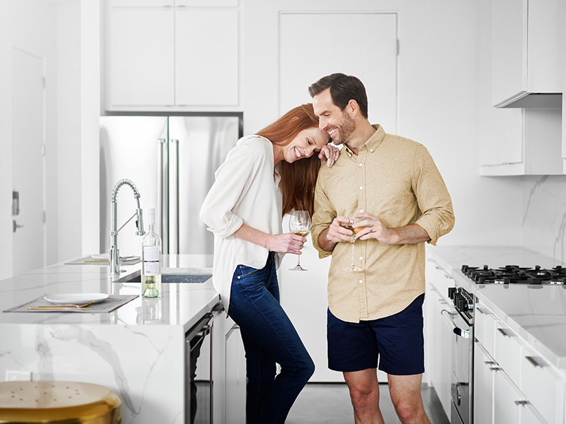 Couple standing in their kitchen together